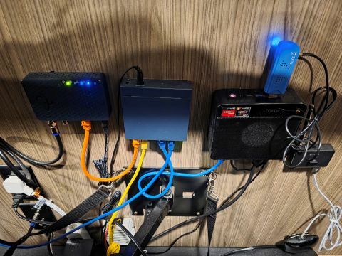 Pictured is the main computer for my home assistant setup, with a network switch and a MoCA adapter.